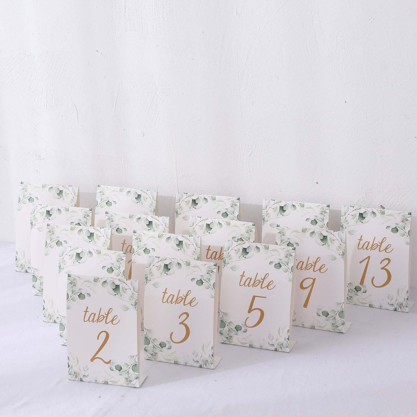 25-Pack Paper Wedding Table Numbers 1-25 White/Green Eucalyptus Leaves Design - Free Standing Double Sided Table Signs with Glam Gold Foil Numbers 7"